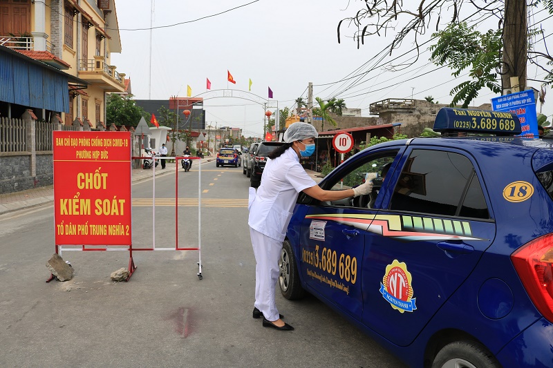 Tổ công tác tại chốt kiểm soát, phòng, chống dịch Covid-19 thuộc TDP Trung Nghĩa, phường Hợp Đức kiểm tra thân nhiệt của người dân