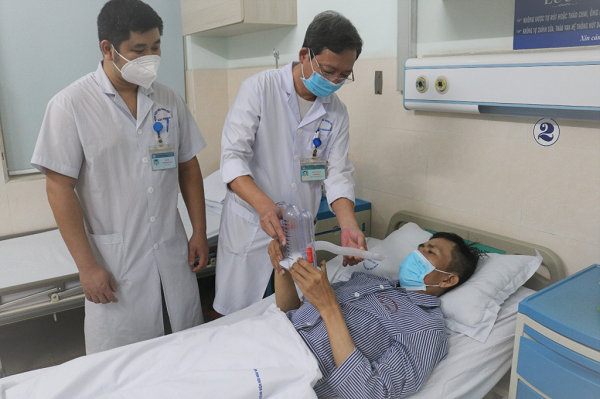 Người bệnh N.V.H được các bác sĩ Khoa Phẫu thuật Lồng ngực Tim mạch thăm khám, hướng dẫn tập thở phục hồi chức năng phổi sau phẫu thuật